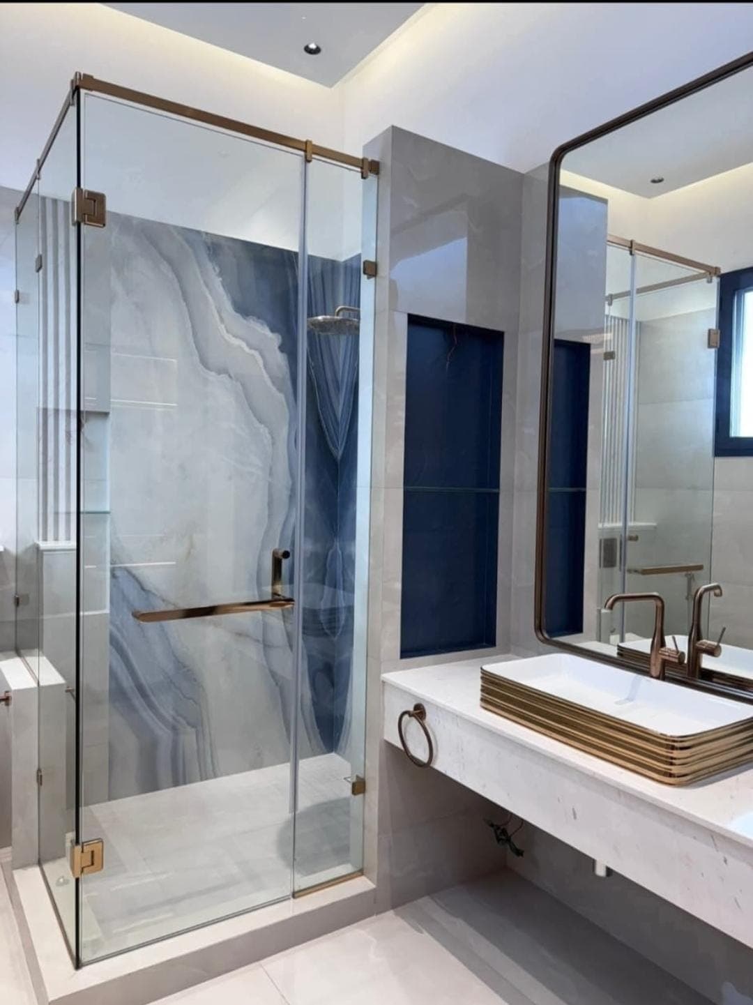 Fixed frameless glass panel beside a walk-in shower